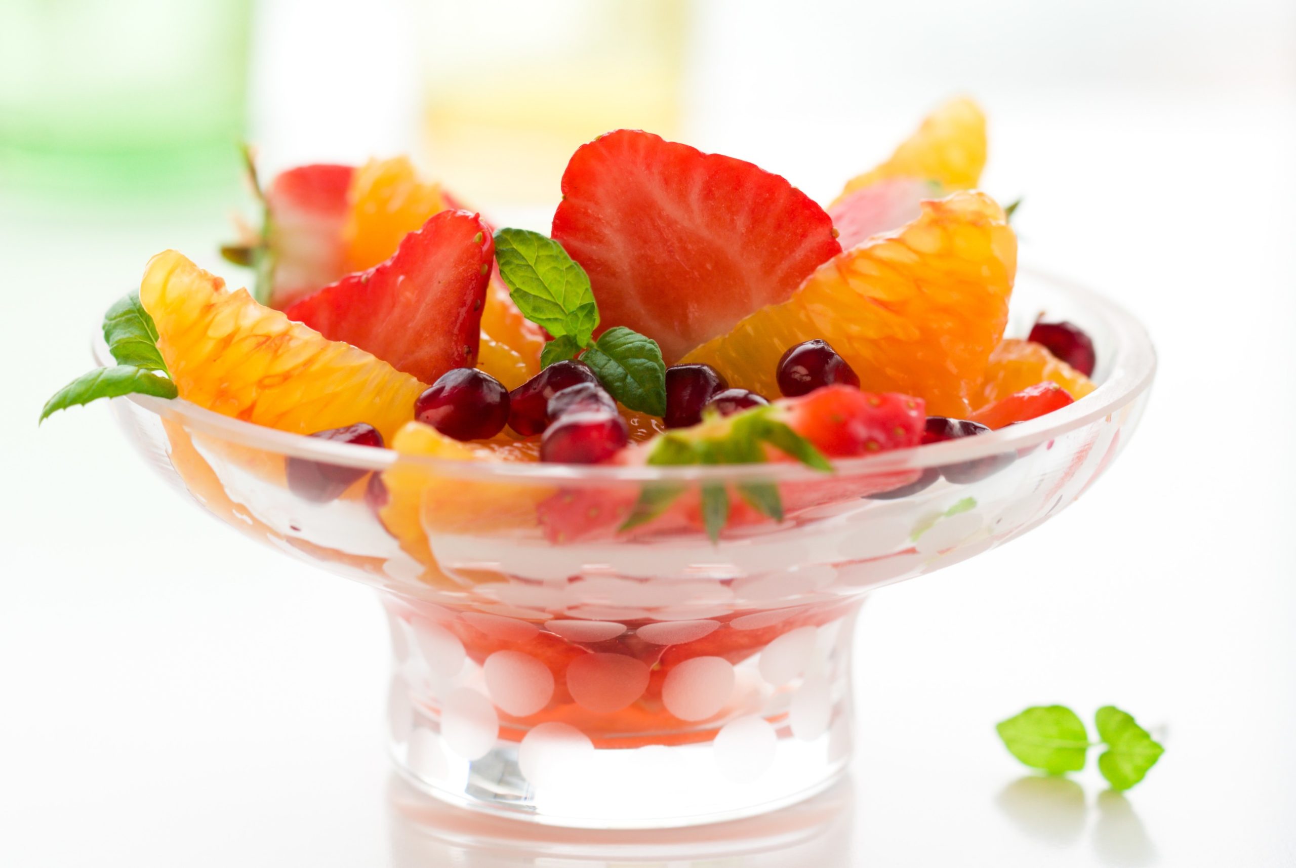 Dessert of strawberry ,orange, pomegranate seeds and mint